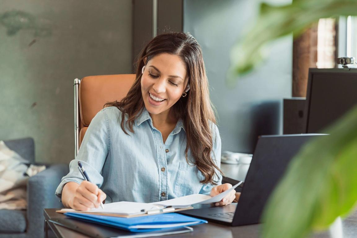 Person reviewing financial progress charts and measurement data